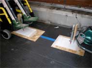 This figure shows Wheelchair-mounted spring-loaded pens and floor targets for recording displacement of wheelchairs during LATV normal and emergency driving conditions.